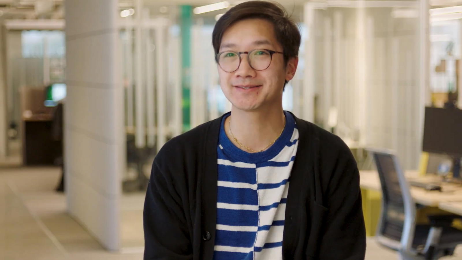 a person wearing glasses and a striped shirt